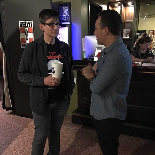 Rodman Flender speaking with an attendee at the screening of his film Eat Brains Love