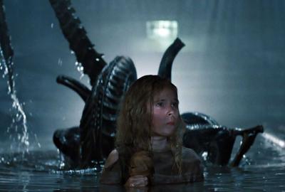 Aliens film still girl with alien behind her