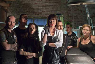 American Mary people standing around a make shift operating room