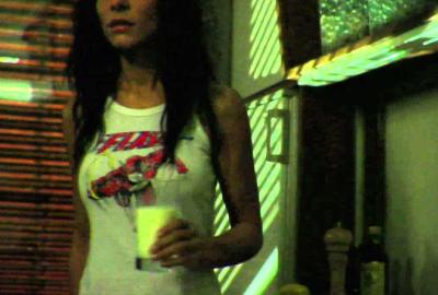 Anyone There? woman in tank top walks with a glass of milk