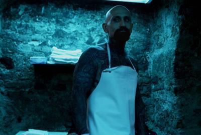 Parlor tattooed man in an apron