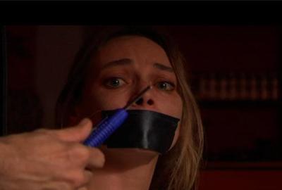 Bad Mistake woman with her mouth taped and being threatened with a knife