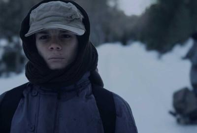 Evaded young man walks in the snow