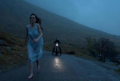 Blackbird film still woman runs in nightgown chased by man on motorcyle