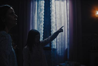 Meat film still of sisters looking at something on the wall