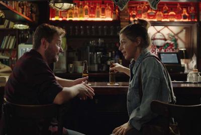 Dana film still couple talking in a bar