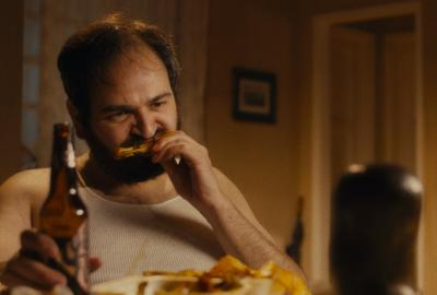 The Occupant film still of a man eating