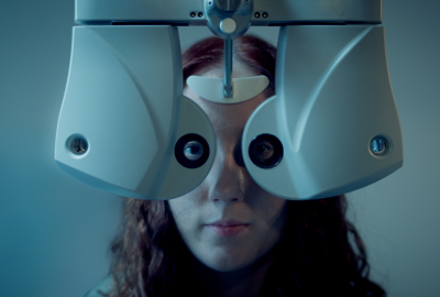 Young woman has her eyes examined