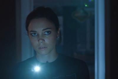 FIRST LIKE film still woman with a flashlight