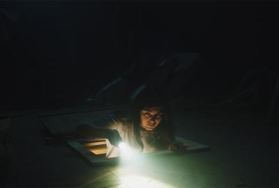 The Burden film still woman climbing into the attic with a flashlight