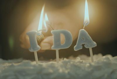 Ida film still candle burning on a cake