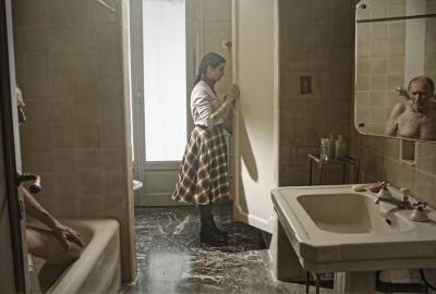 Imaginary Portrait film still young woman opening a door in the bathroom with creepy man in the bathtub