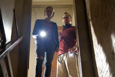 The Innkeepers a couple uses a flashlight to look into the basement