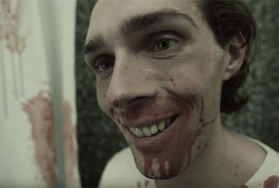  It's a Boy film still man smiling with bloody mouth