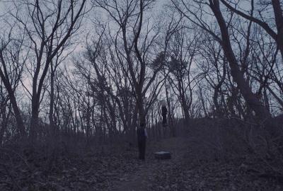 LeaveWork film still man in the woods with a box