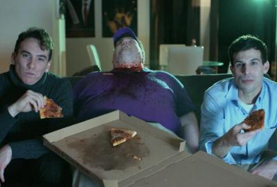 Killer Date film still dead man, playing video games and eating pizza.