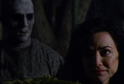 Lakeland film still of woman with creepy dead man behind her