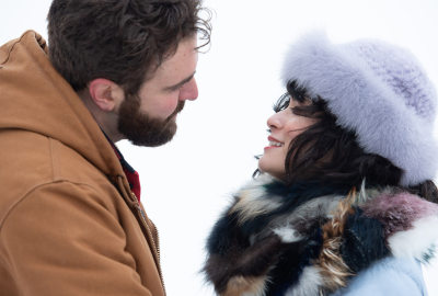 A couple talking to one another in the snow