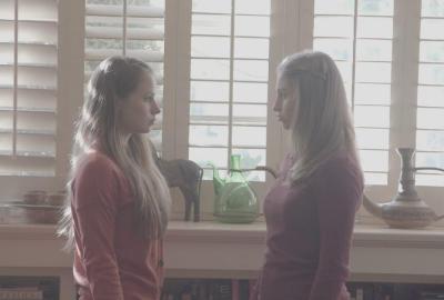 The Perfect Family film still two young women talking to each other.