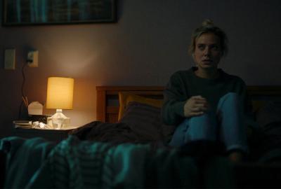 The Departure film still woman sitting on bed