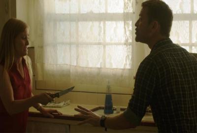 A Mother's Love film still woman holds a knife to her husband in the kitchen