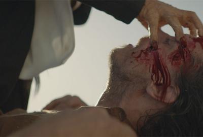 Nagual: The Sin Eater film still man puts fingers in other mans eyes