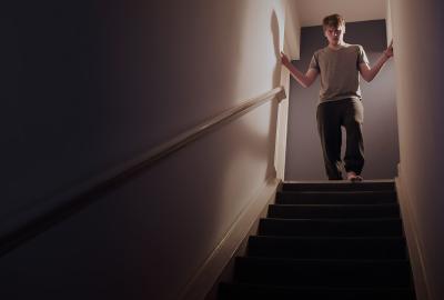 Ouroboros film still man looks down staircase