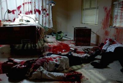 Parasomnia bloodied man lays on the floor of a bloody room