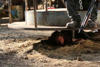 Preservation person hides under playground spin toy