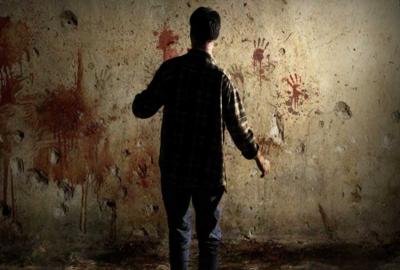 Recollection man looks at a bloody wall