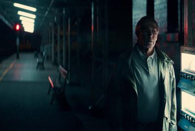 REFORMED film still man standing in a subway station