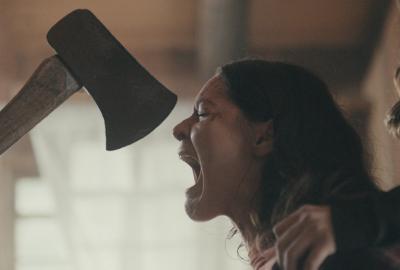 The Rule of Three film still woman with an axe almost in her face