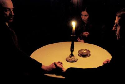 Seance people sitting around a table performing a seance