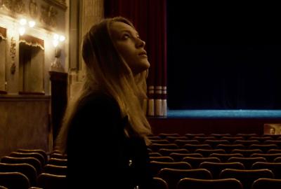 Laura looks up at the huge auditorium