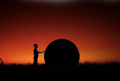 The Landing man touches circular object in a field