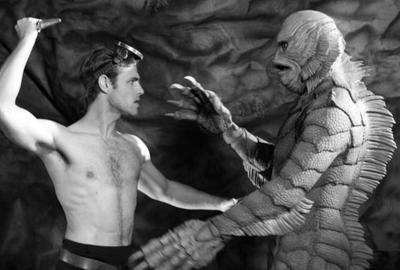 United Monster Talent Agency man threatens creature from the black lagoon with a knife