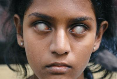 Vikaari film still young girl staring with white eyes