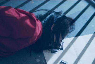 Warm Blood film still dead woman with polaroid photos near her head