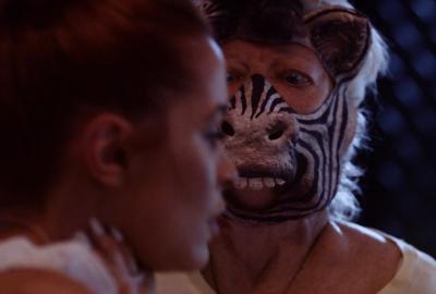 Zebra film still of a zebra masked woman