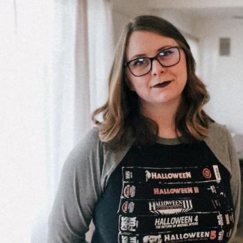 Writer/Director Shannon Brown, a female filmmaker with brown curled hair and glasses