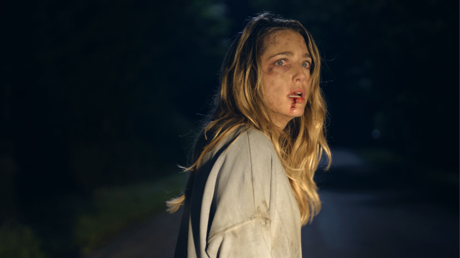Film still from the Opening Night Film Affection: woman with bloody face looks back
